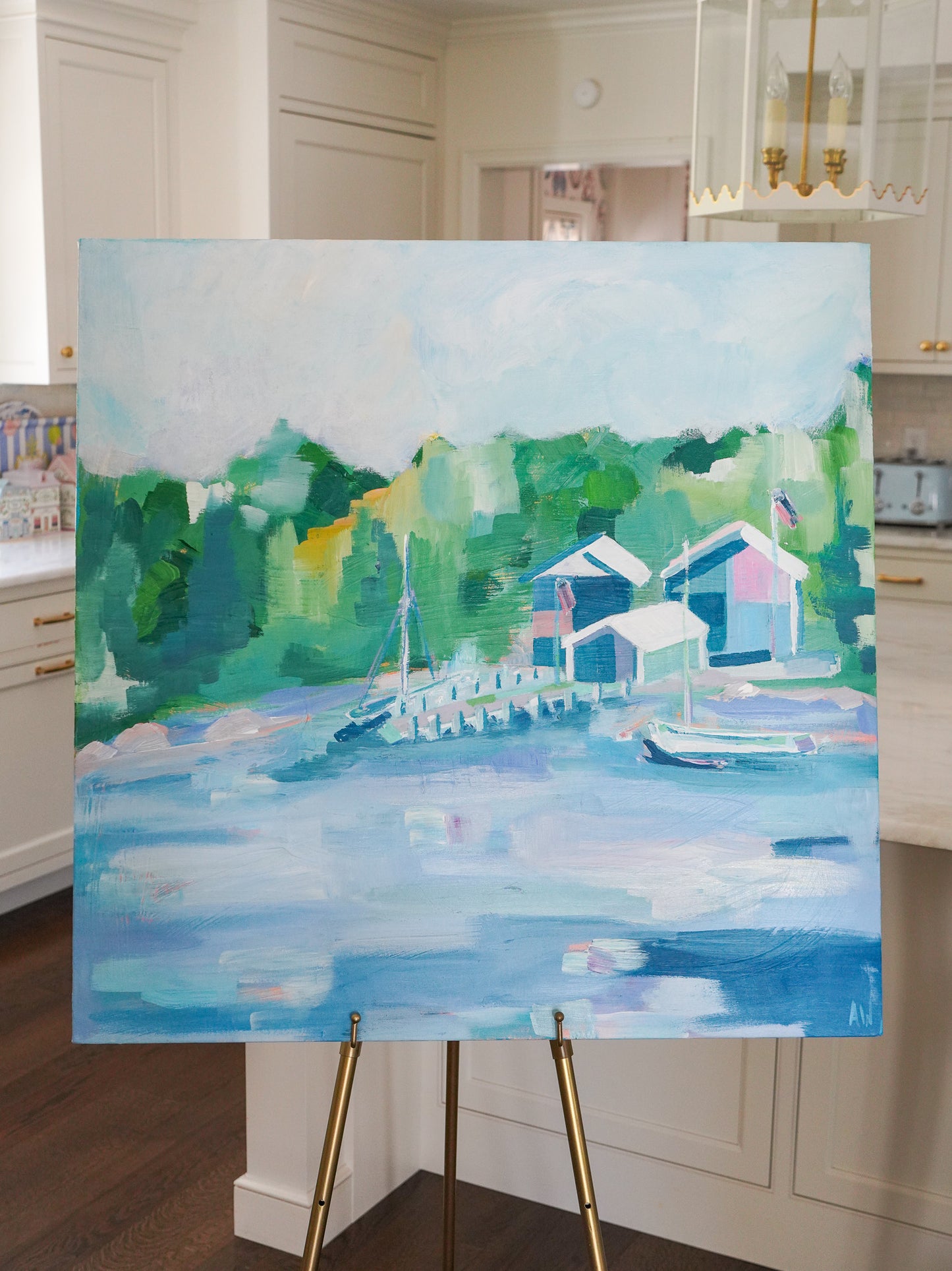 Tranquil painting titled Les Cheneaux featuring boathouses and docks along calm waters, surrounded by lush greenery, inspired by Michigan’s Upper Peninsula.