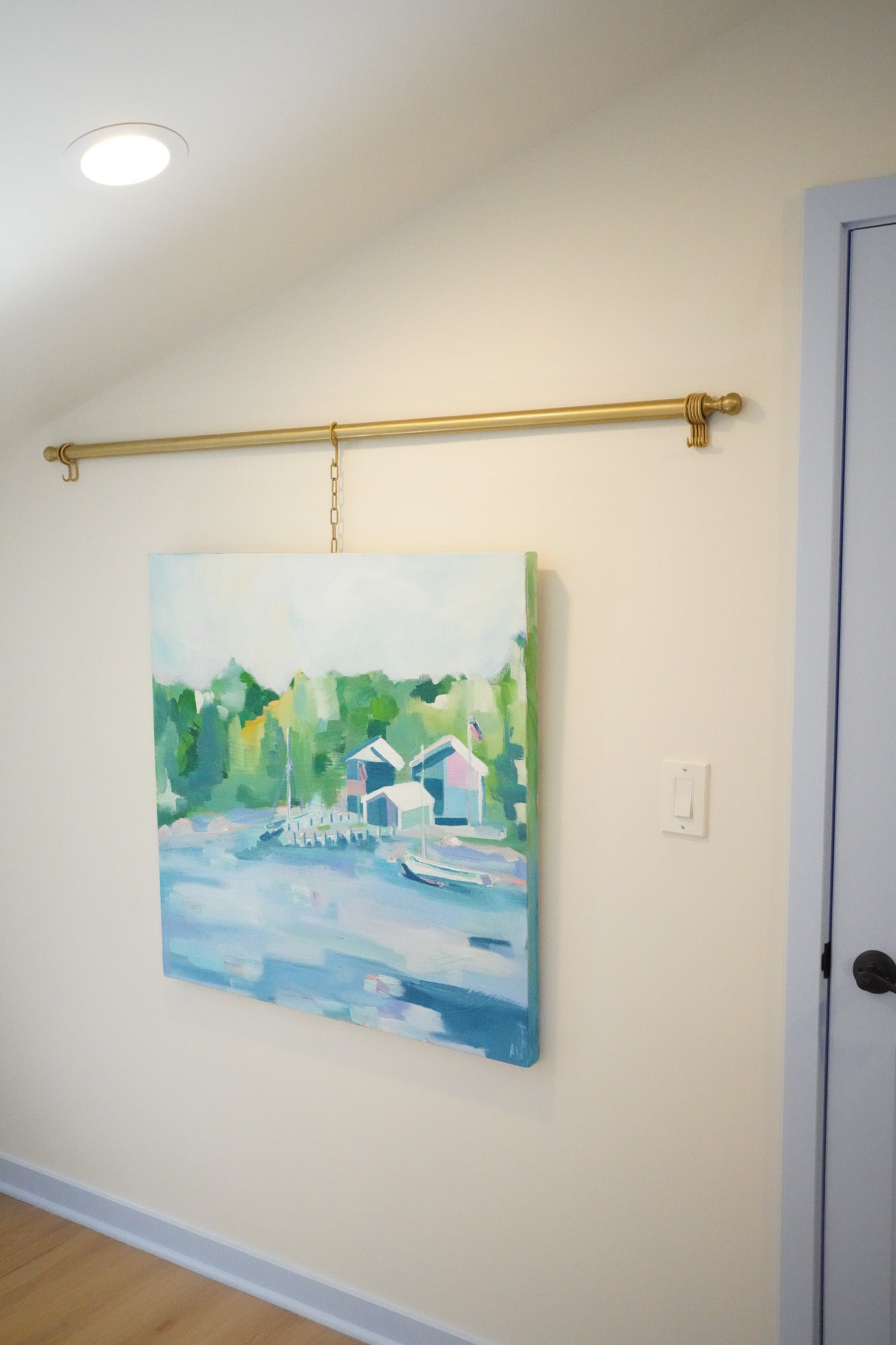 Tranquil painting titled Les Cheneaux featuring boathouses and docks along calm waters, surrounded by lush greenery, inspired by Michigan’s Upper Peninsula.