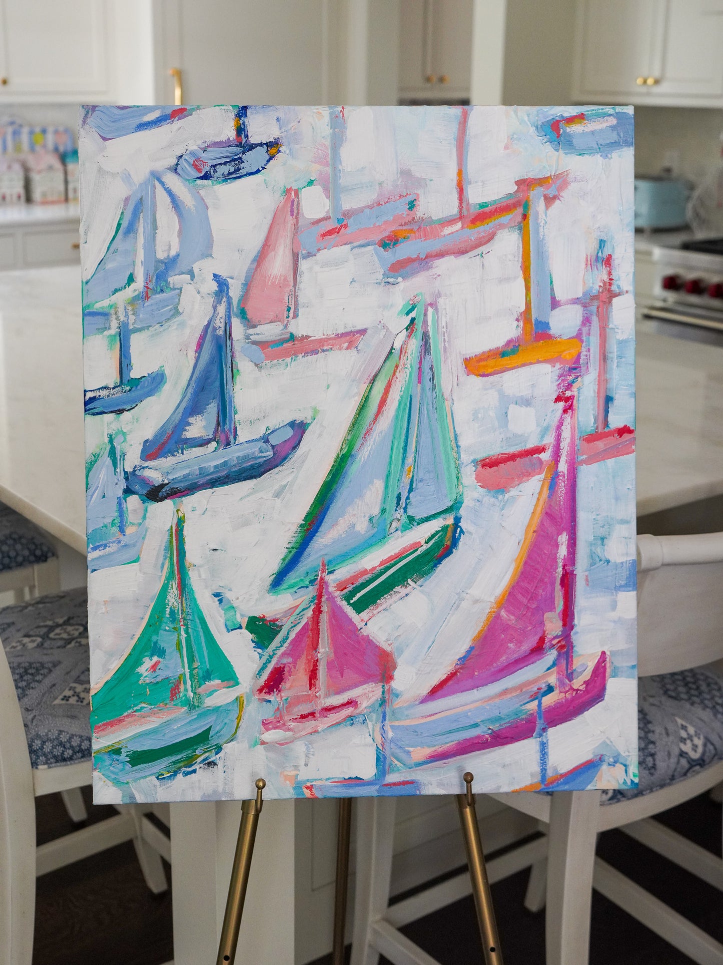 Abstract painting titled Boyne featuring colorful sailboats in vibrant pink, teal, and blue, inspired by the lively movement of sailboats in Northern Michigan.