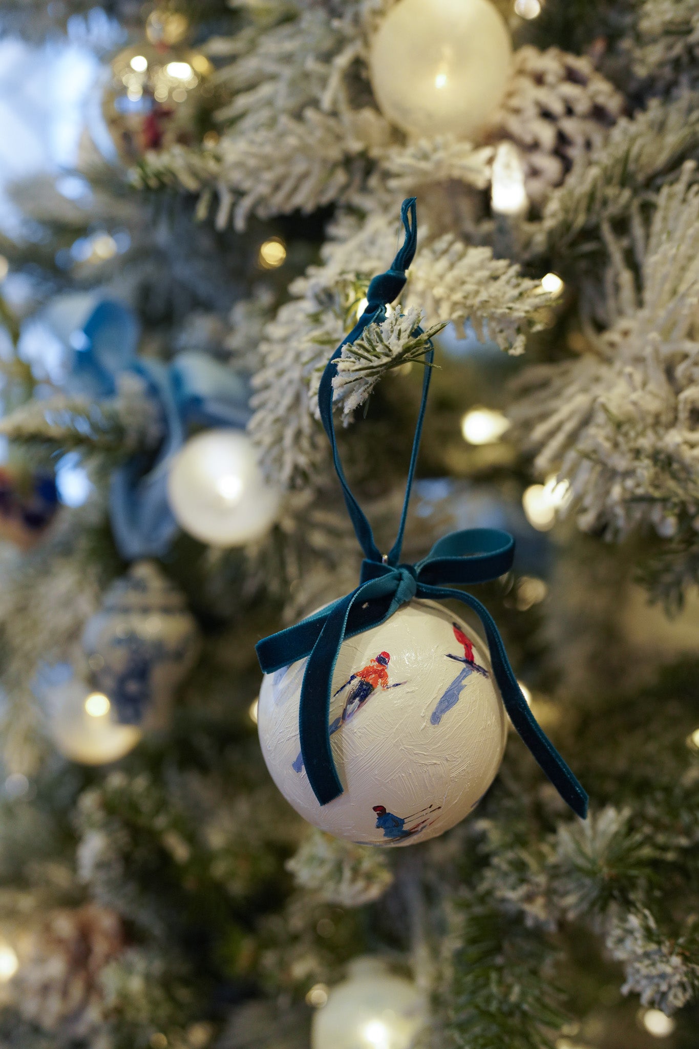 Decorative ornament with a blue ribbon on a Christmas tree