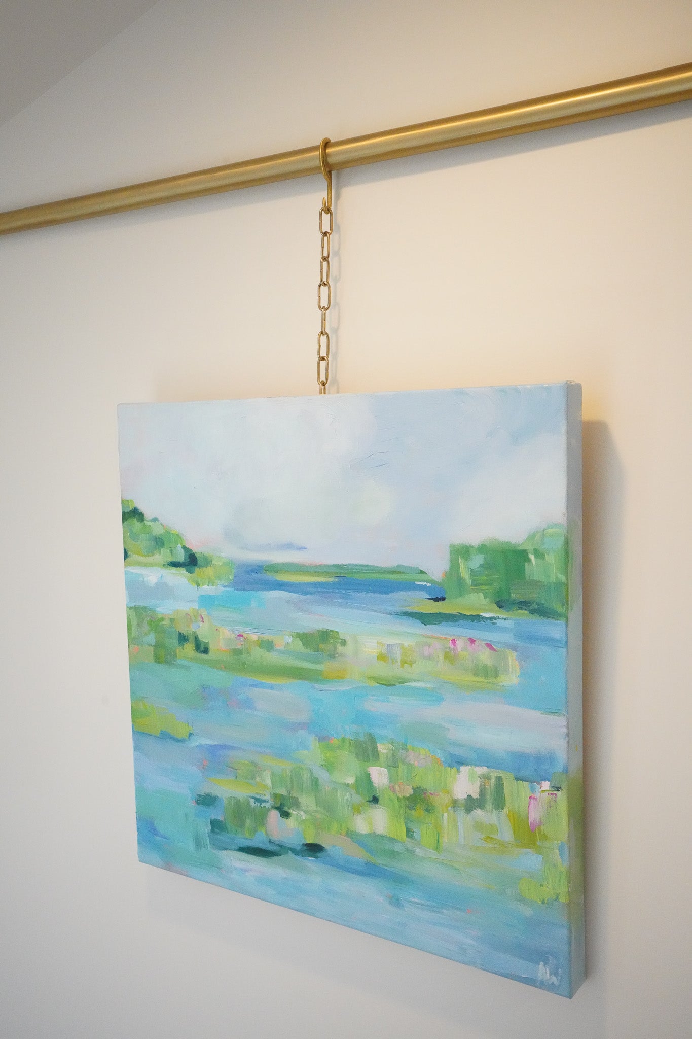 Abstract painting titled The Point featuring a serene waterway and lush greenery with soft blues, greens, and hints of pink, inspired by Michigan’s natural landscapes.