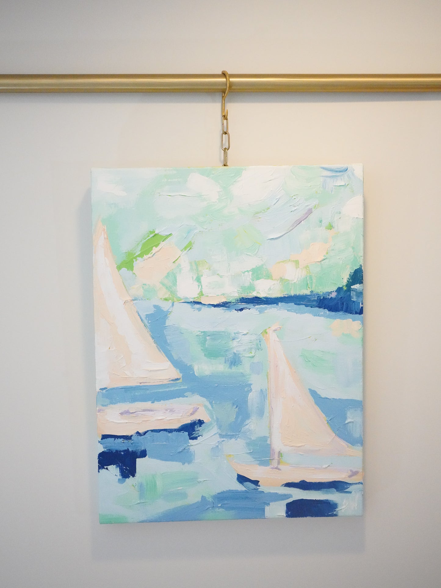 Inspired by Hessel, Michigan. Two sailboats in an abstract style landscape acrylic painting. Colors of blue, peach and green set the scene for a windy summer day on the water. Thick strokes of paint and many layers create movement and a dynamic look.