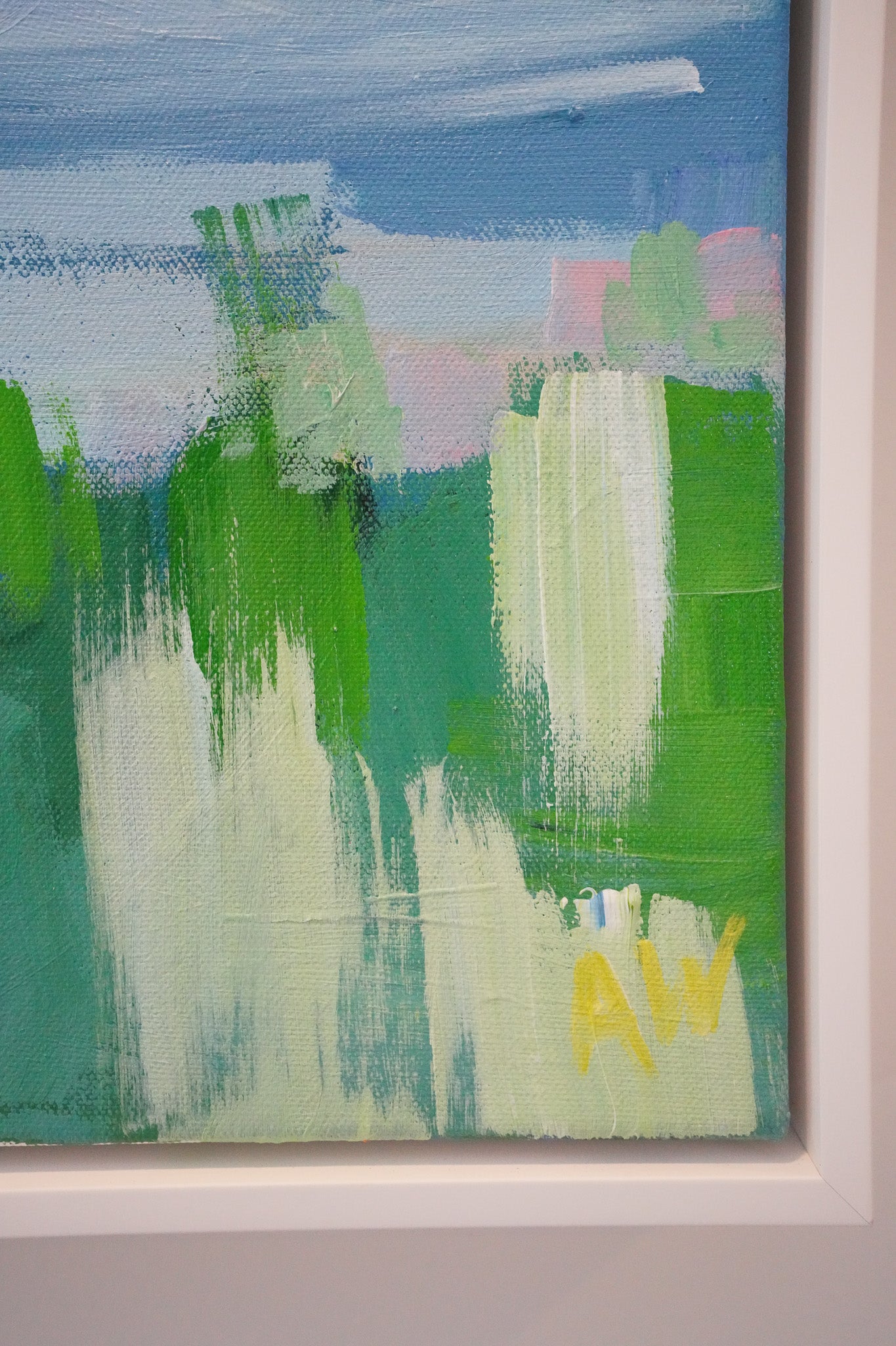 A detail photo of a larger acrylic painting inspired by northern Michigan. The details shown are loose green and yellow textured strokes representing grass and marshland. 